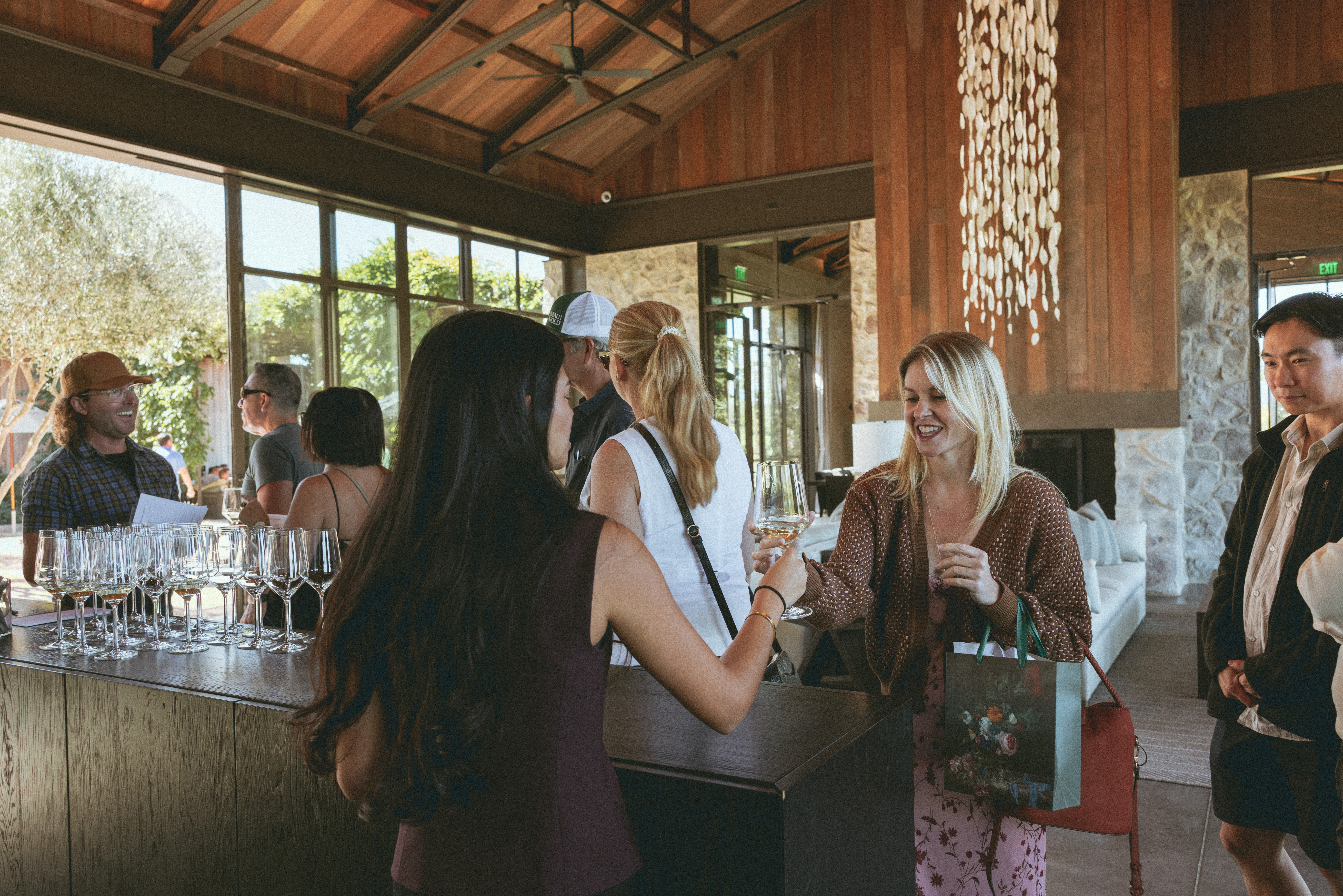 Guests socializing and enjoying wine during an Allocation Event at Brave & Maiden Estate.