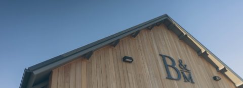 Roof of winery with logo on wall