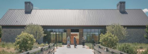 Wide shot of Brave & Maiden entrance with family walking toward tasting room