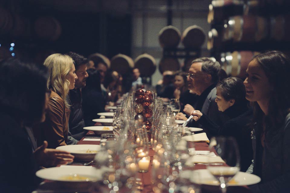 Guests at dinner table in barrel room